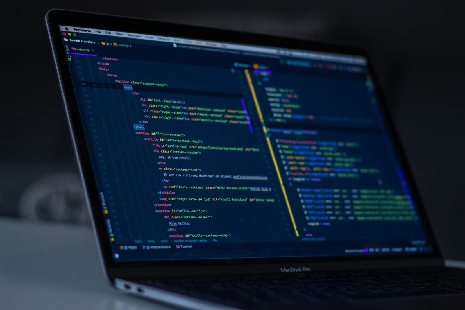 Laptop showing code on a dark editor